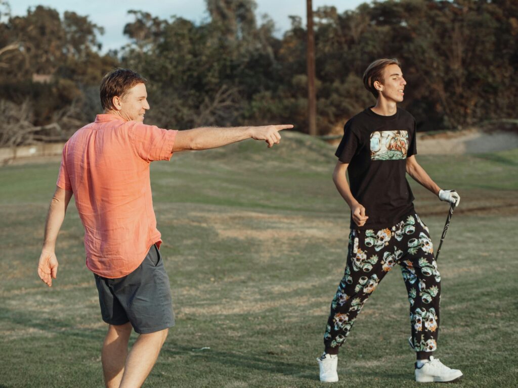 father and son having fun while playing golf