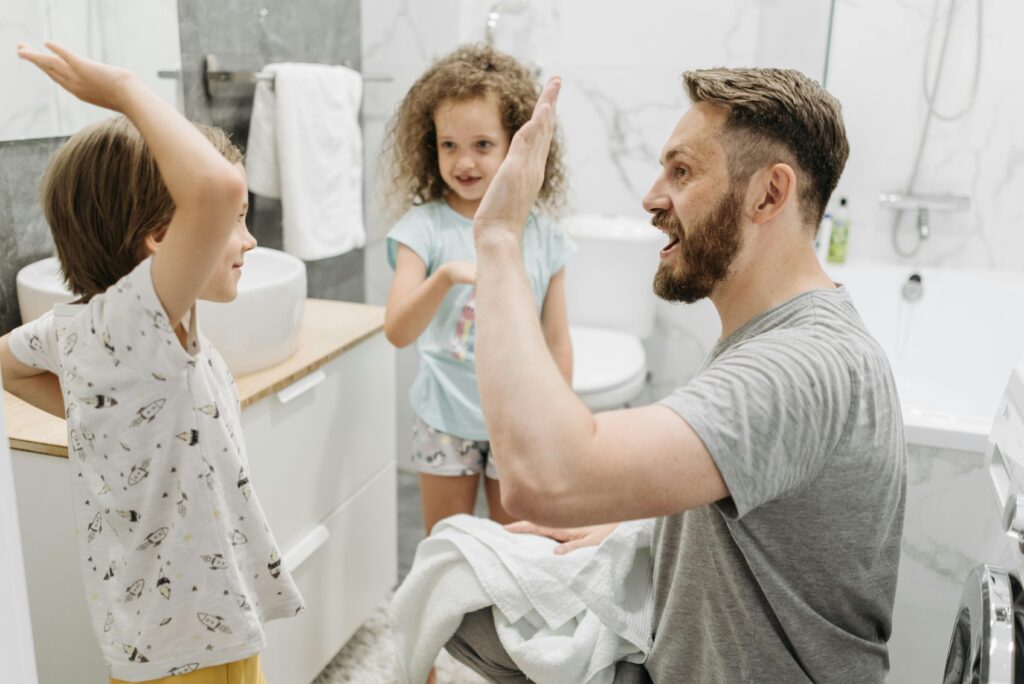 Father giving a high five to his responsible child for doing a chore