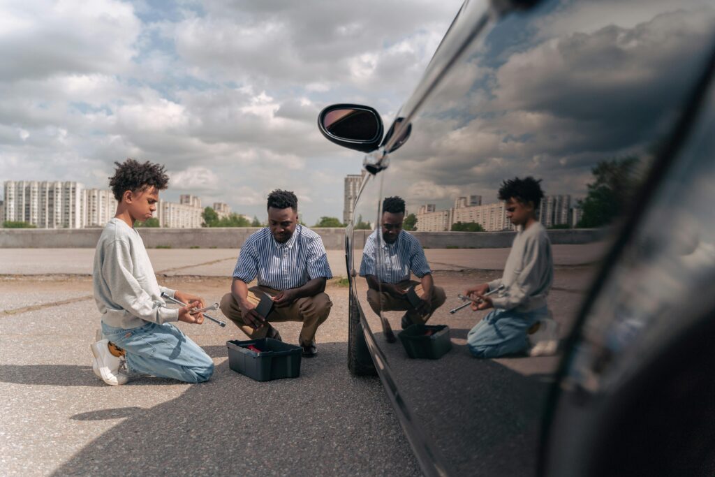 father asking his son for advice on repairing his car