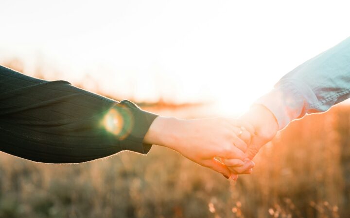 couple holding hands as they decide never to fight about money ever again