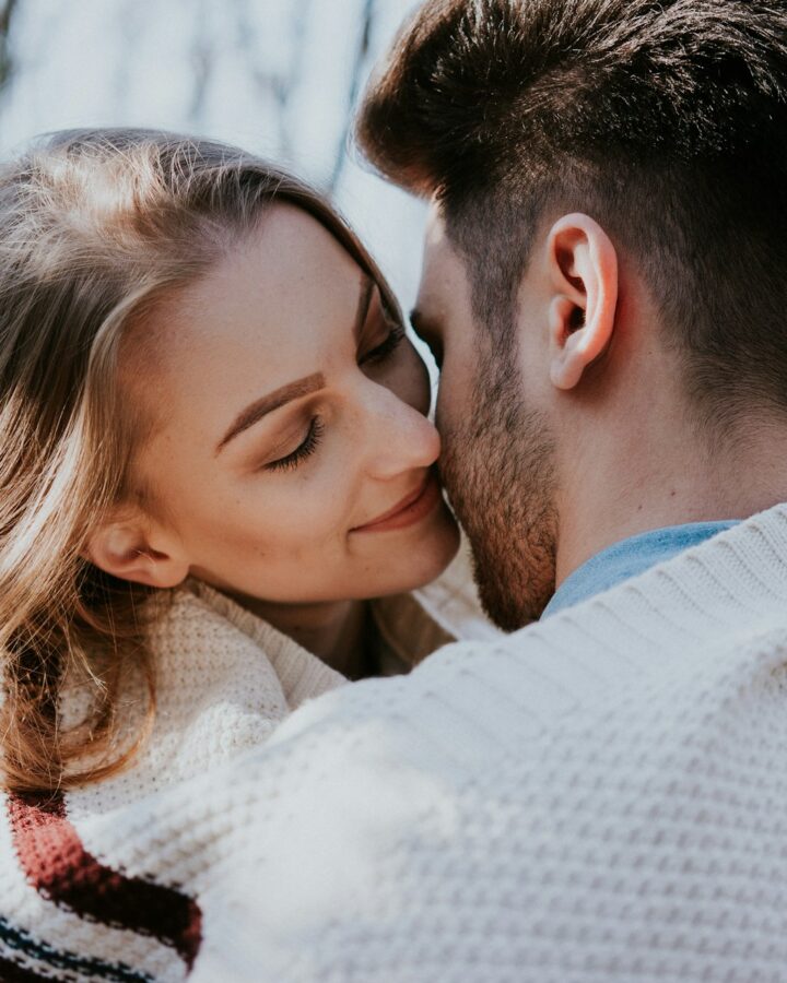 Man and woman almost kissing. Woman secretly thinking how she can change her partner